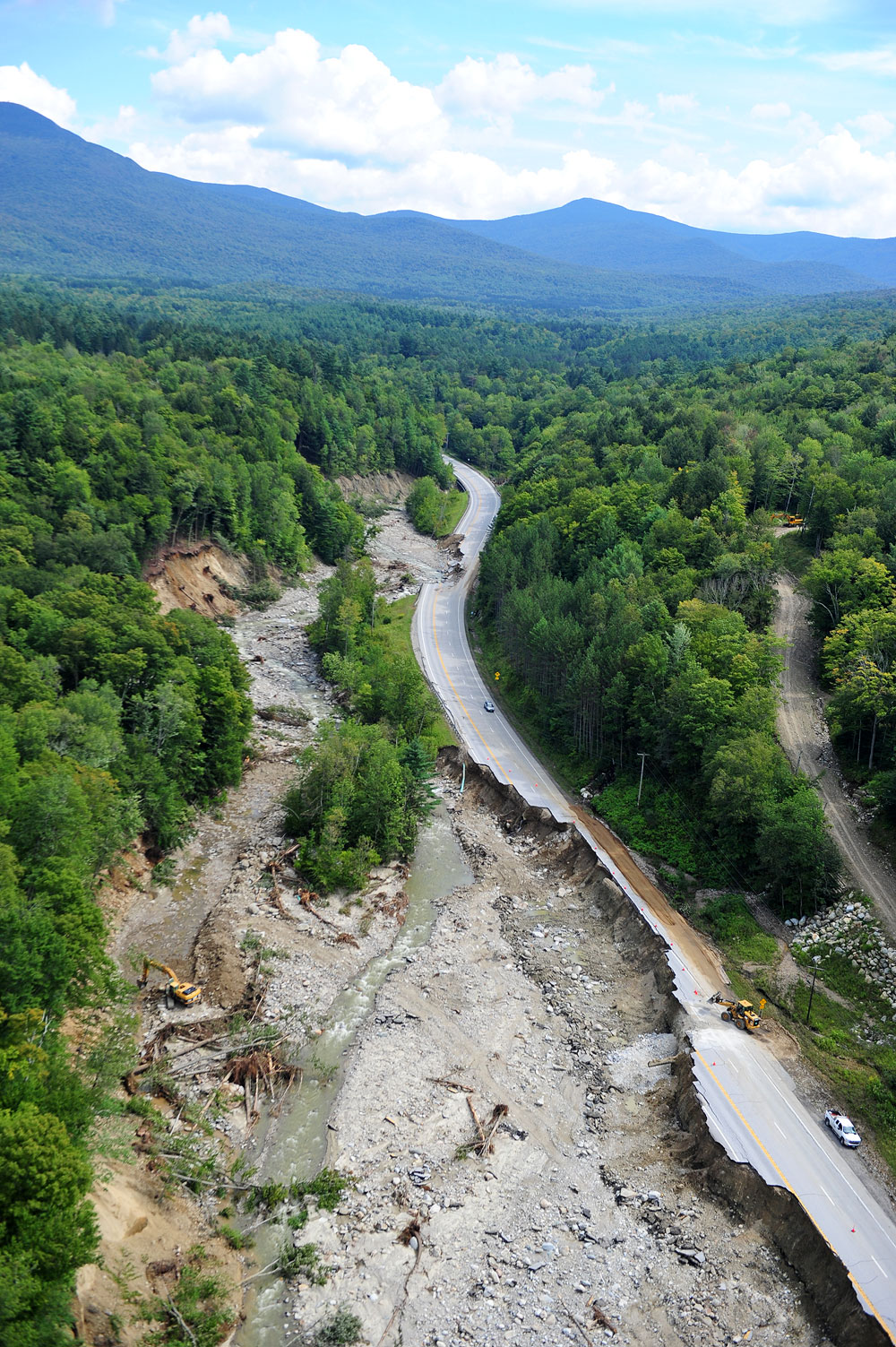 Aerial view of Route 4 damage in Vermont after Hurricane Irene — the road runs alongside a completely scoured riverbed, with the embankment washed away. Courtesy of Mansfield Heliflight.